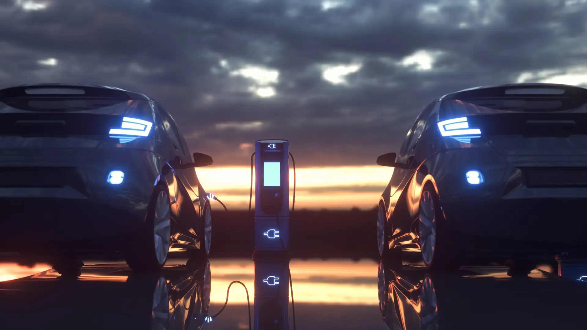 Zwei Elektroautos an einer beleuchteten Ladestation in der Abenddämmerung